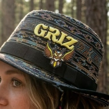 Young woman wearing GRiZ festival hat on Electric Forest Sherwood Forest owl rave sprout clipped on rave hat brim