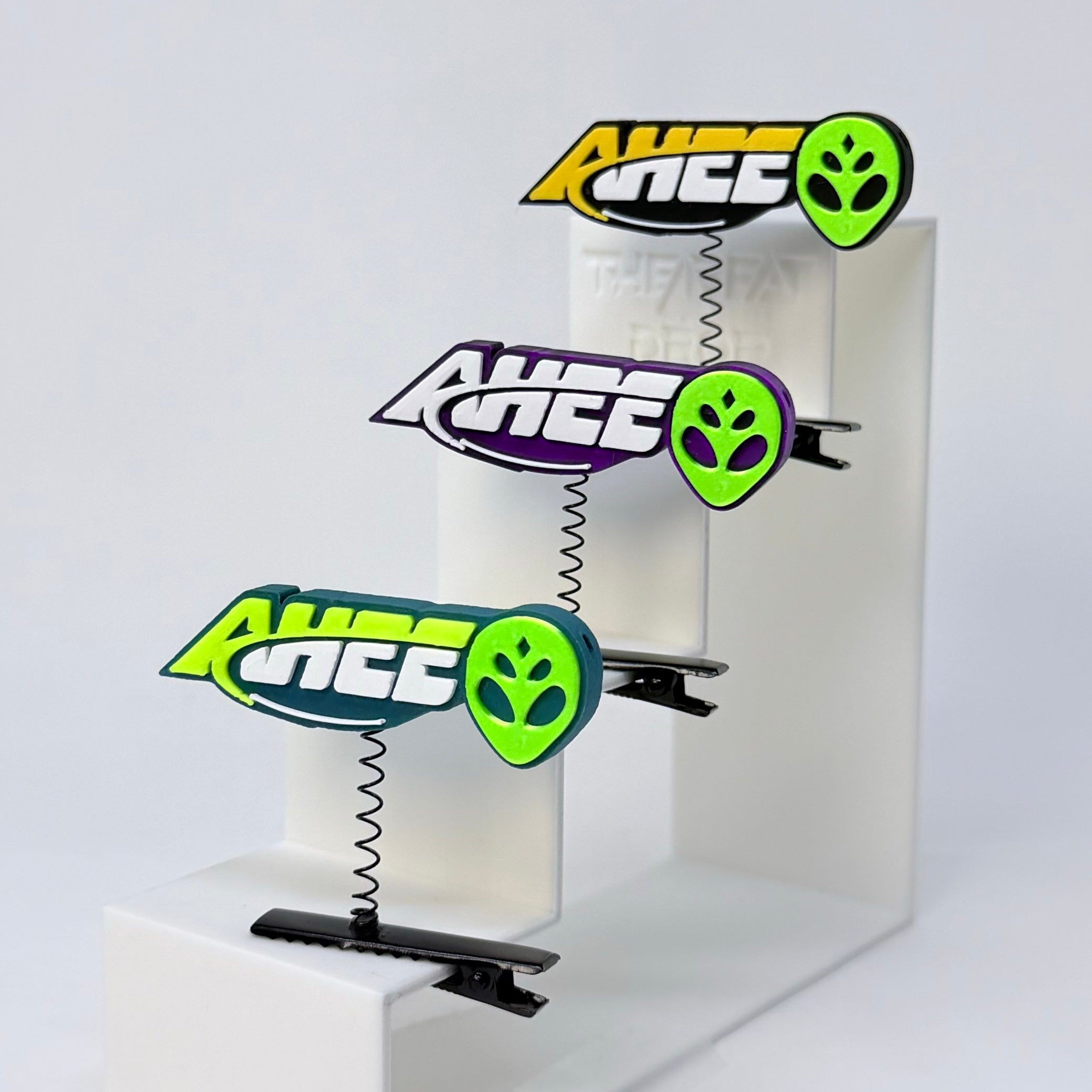 AHEE Alien Rave Sprout black purple turquoise rave hair clips displayed on white acrylic steps