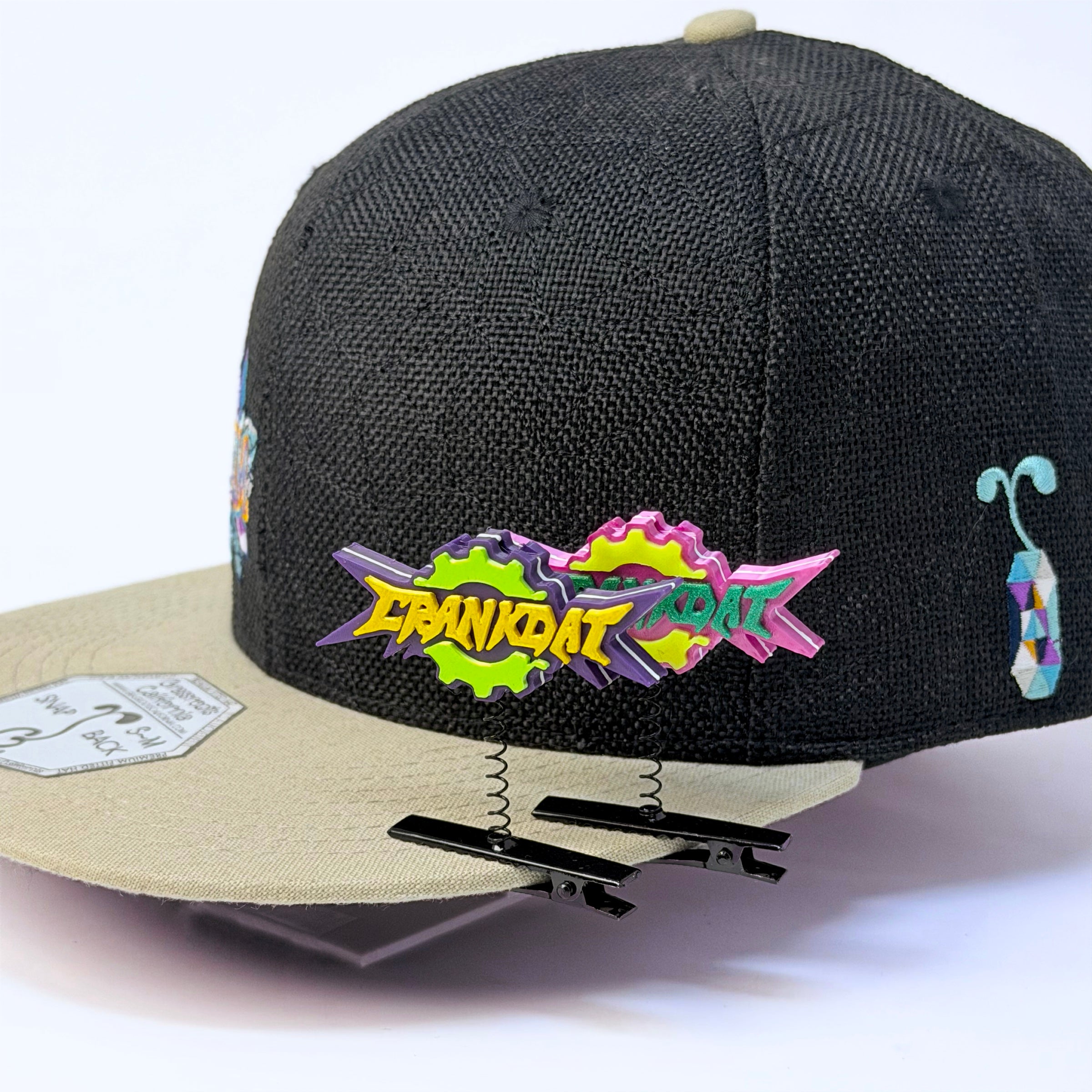 Crankdat logo rave sprout multi-color clipped to a hat — EDM bass music festival hair clip accessory
