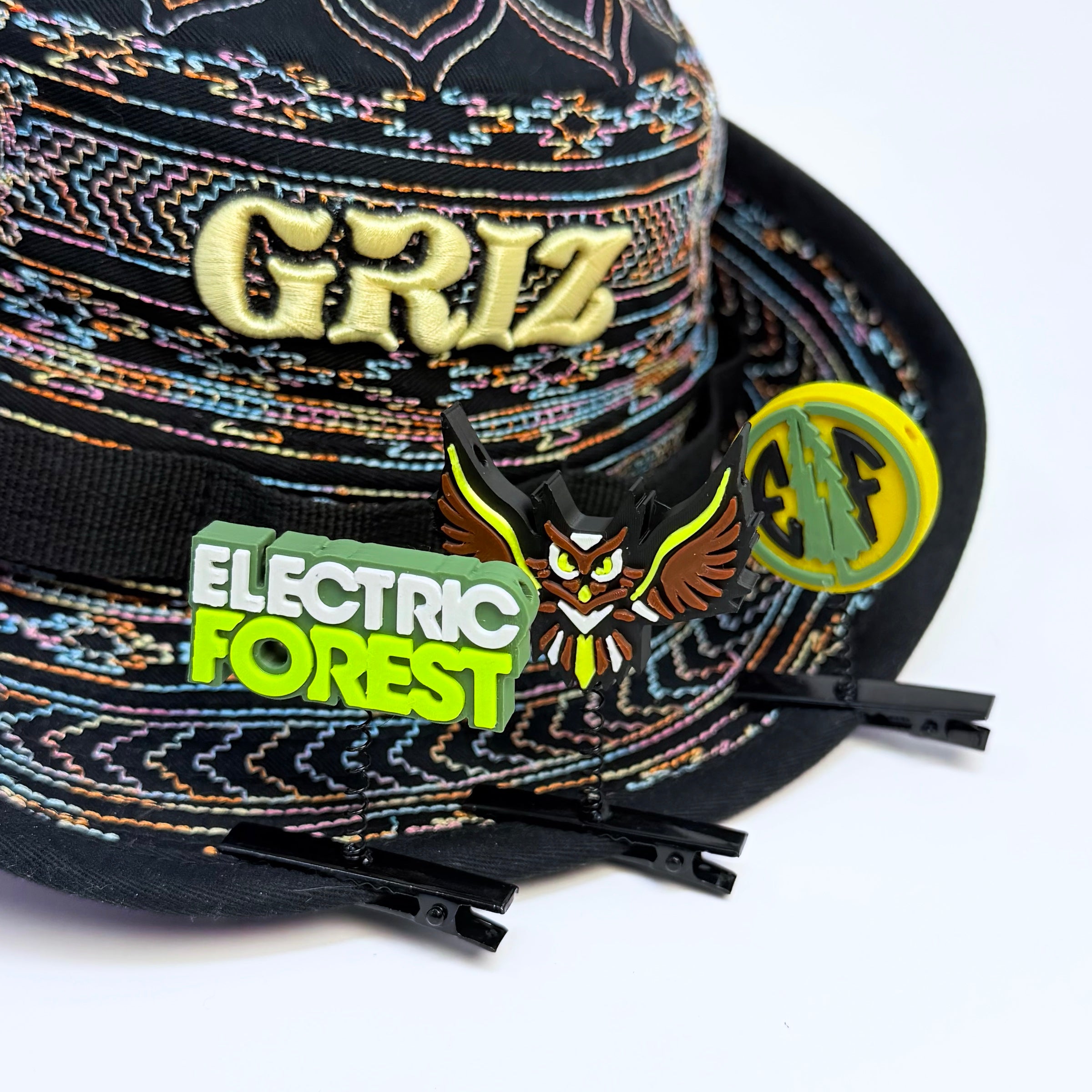 Electric Forest rave sprout bundle featuring Sherwood forest owl, EF text sign, and forest coin 3D printed festival hat clips on an embroidered GRiZ bucket hat