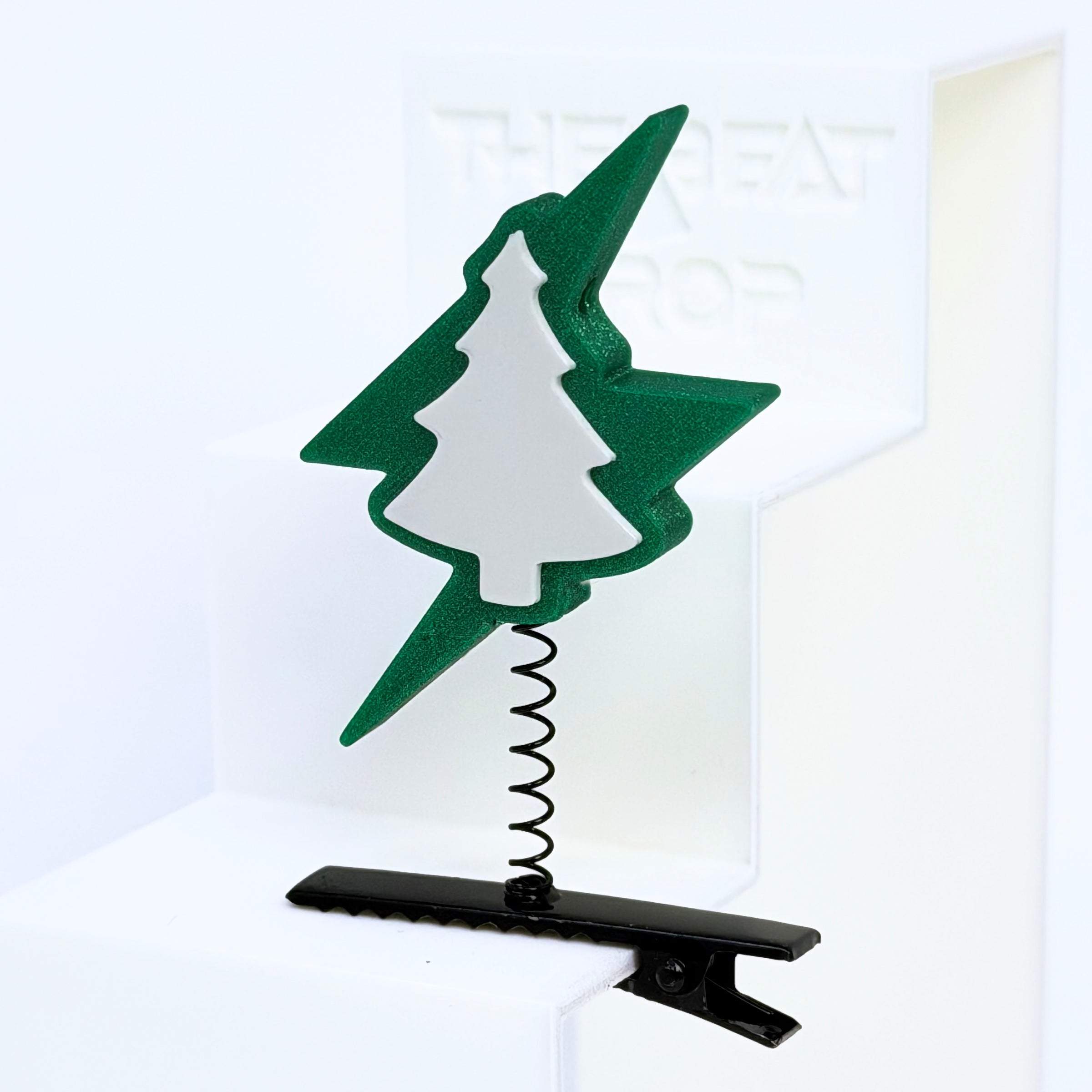 Close-up of Electric Forest lightning bolt rave sprout in forest green with white pine tree cutout, mounted on black metal spring hair clip