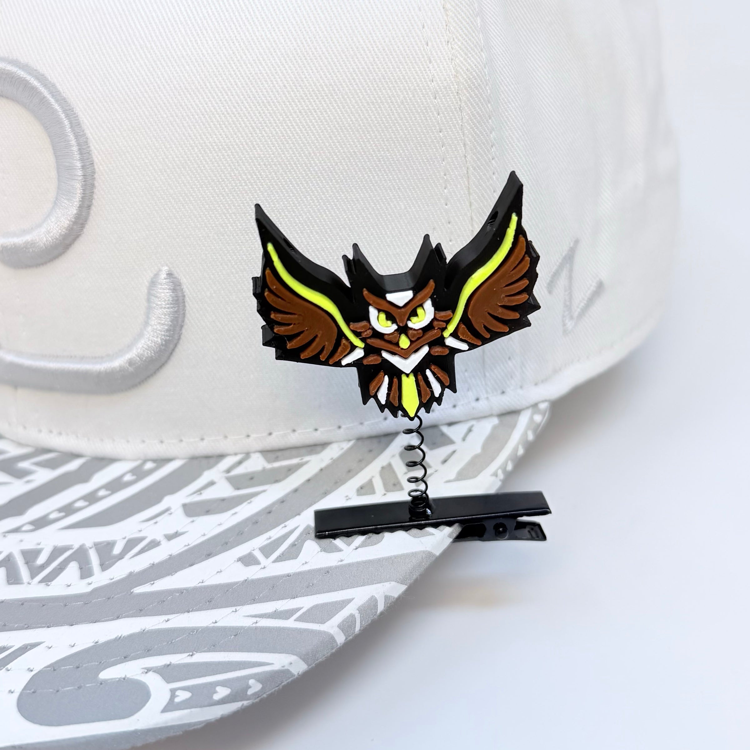 Electric Forest Sherwood Forest owl rave sprout clipped to white festival hat – EDM music festival hair clip shown on rave hat brim