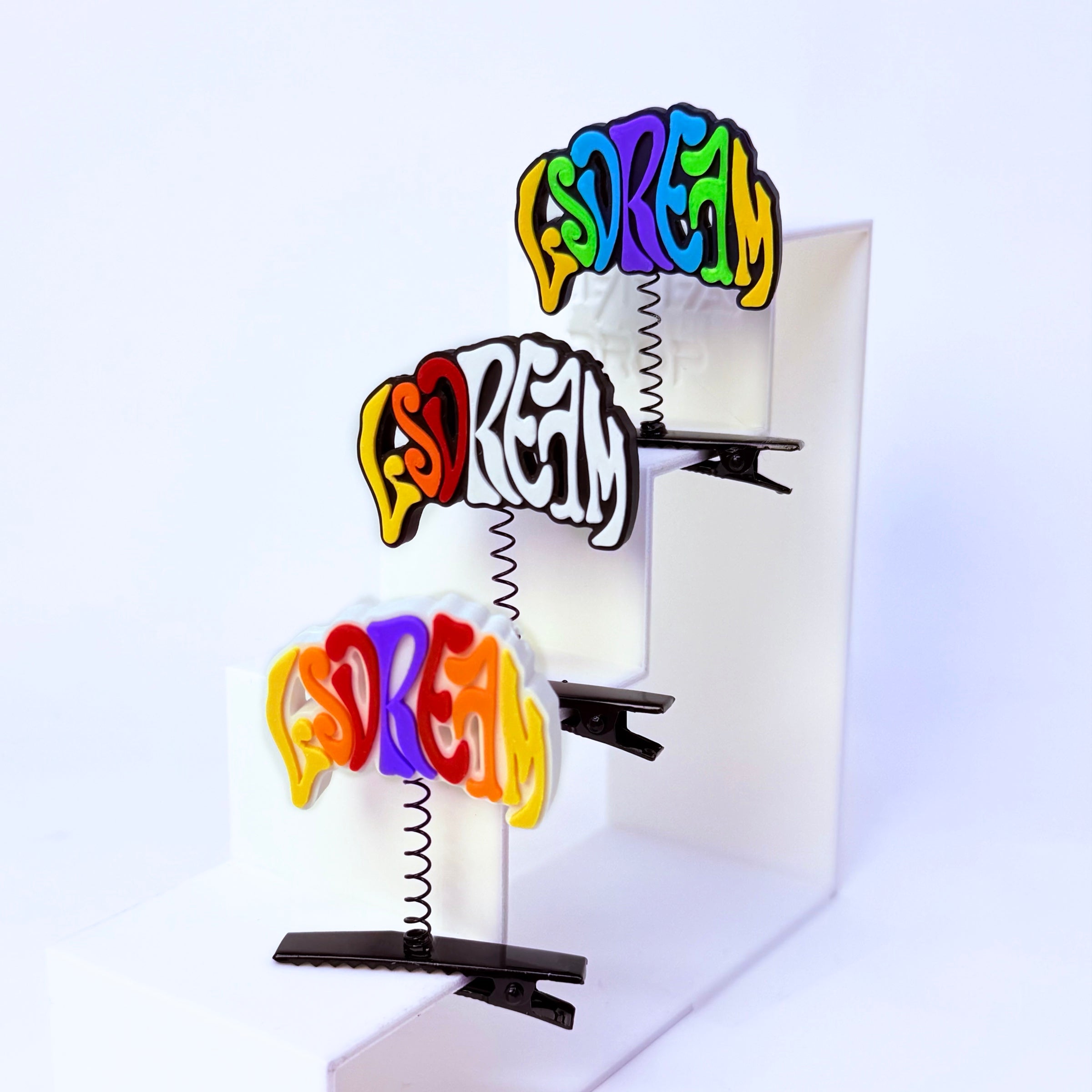 LSDream psychedelic rave sprout multicolor — EDM festival hair clip accessory clipped to white multilevel display
