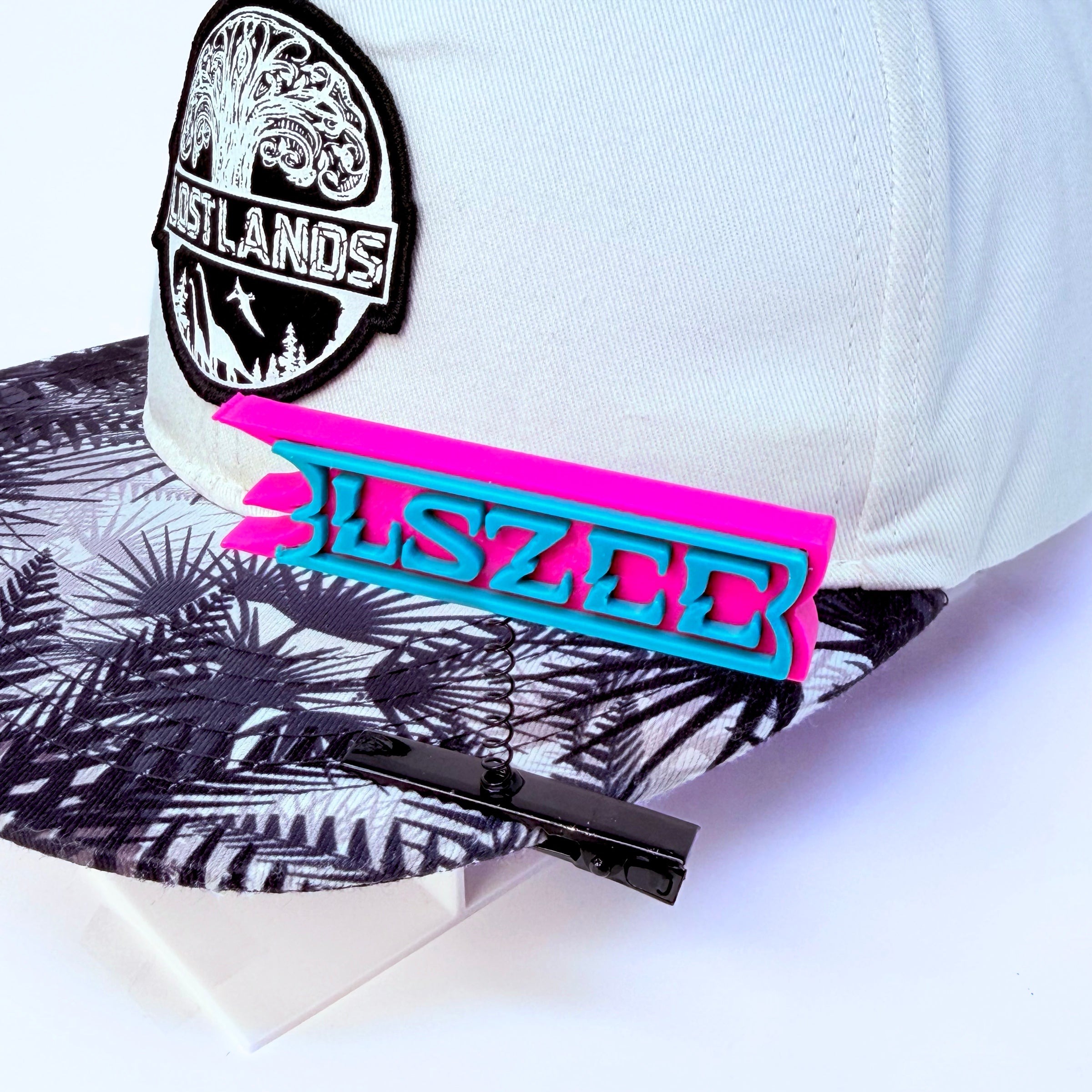 LSZEE pink background and blue text rave sprout — CloZee LSDream EDM festival hair clip clipped to Lost Lands rave hat