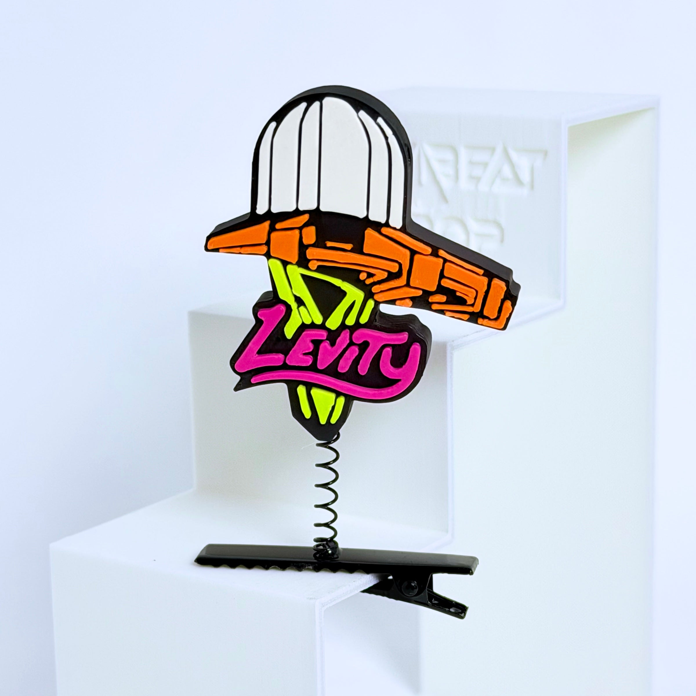 Black Levity Lasership rave sprout — bold 3D printed festival accessory with metal spring clip, orange and neon green accent colors