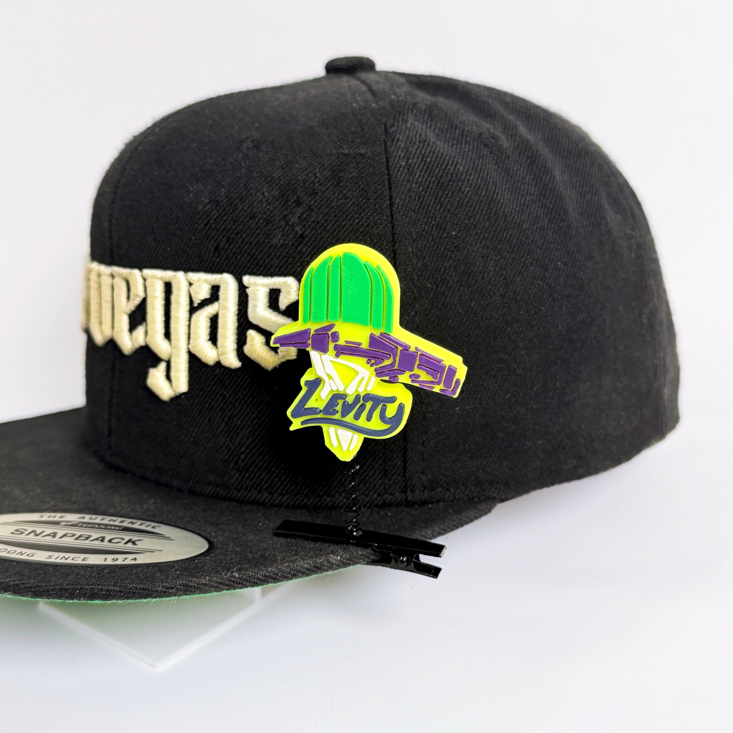 Fan-inspired Levity rave sprout clipped to a black snapback hat — EDM festival hair clip worn as a rave accessory at music events