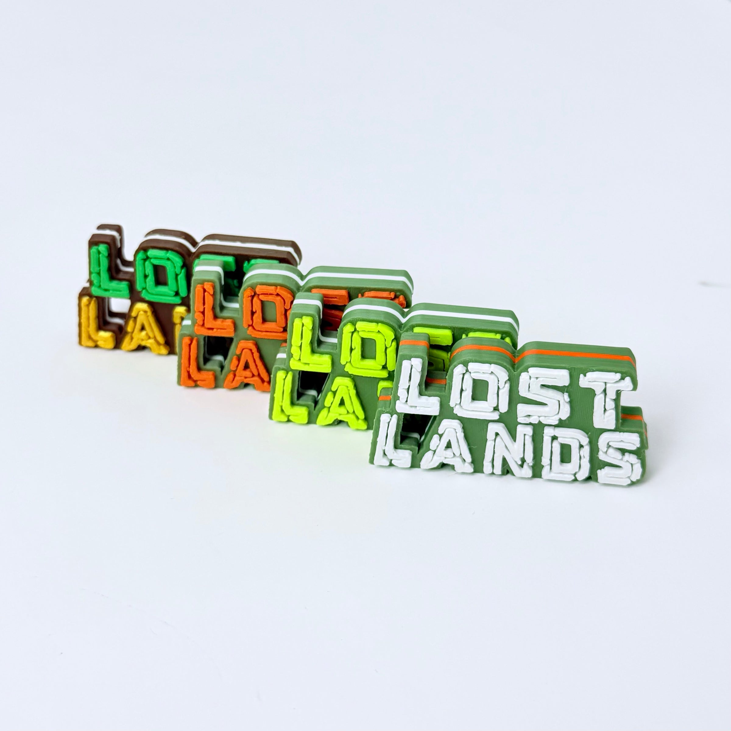 A set of colorful 3D block letters spelling out 'LOST LANDS' on a plain white background.
