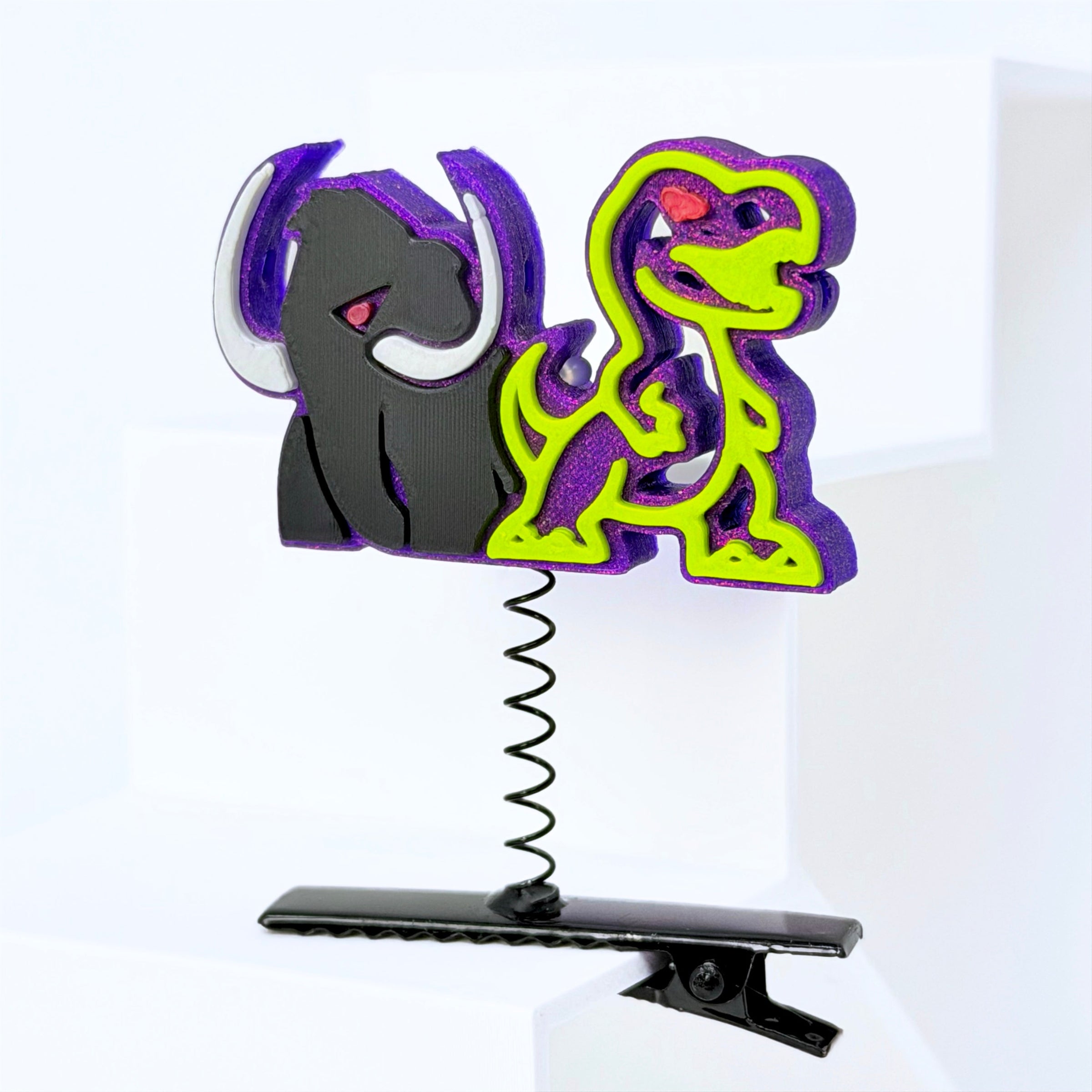 A rave sprout featuring a black Wooli and a neon yellow Lost Lands T-Rex dinosaur on a purple background, mounted on a black spring and clip base.